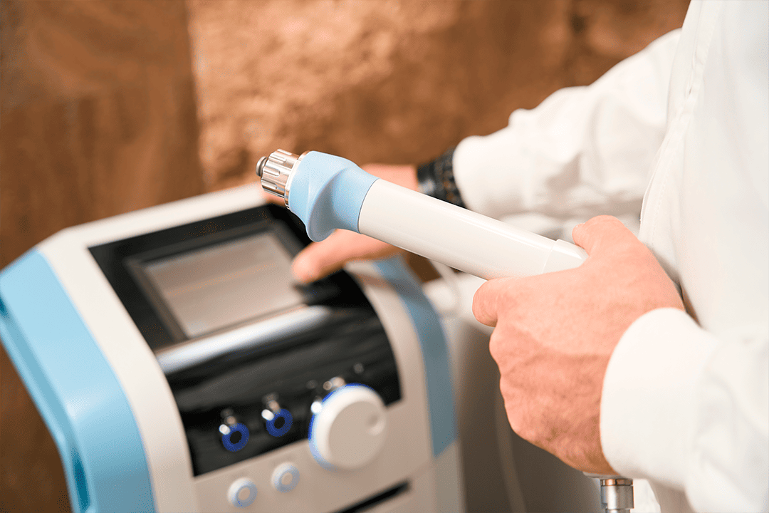 shockwave therapy machine being manipulated by a doctor.